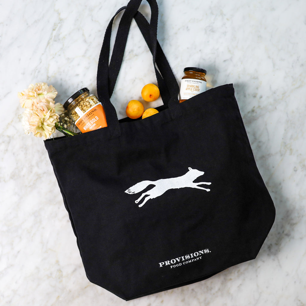 Stylish black tote bag featuring a charming foxy design.